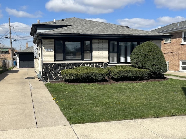 bungalow-style house with a front lawn and roof with shingles