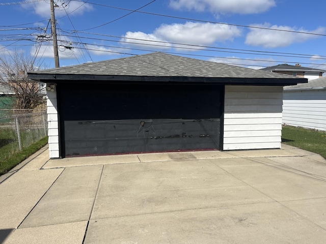 detached garage featuring fence