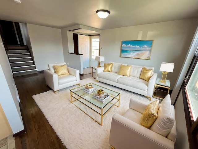 living area with stairs and wood finished floors