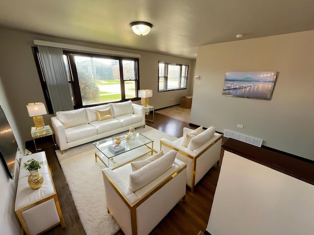 living room featuring visible vents and dark wood-style floors