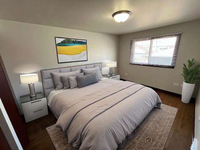 bedroom with dark wood-style flooring