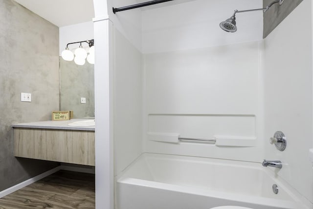bathroom featuring bathtub / shower combination, vanity, and wood finished floors