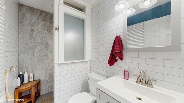 2606 Martin Dr, Spring Grove, IL 60081 - bathroom featuring tasteful backsplash, tile walls, toilet, vanity, and a walk in shower