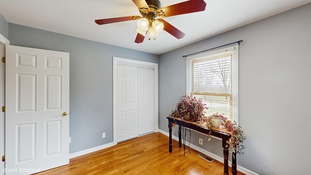 2606 Martin Dr, Spring Grove, IL 60081 - bedroom with light wood finished floors, baseboards, visible vents, a closet, and ceiling fan