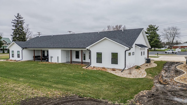 1017 S Sixth St Unit 1, Princeton, IL 61356 - back of property with a yard, a shingled roof, cooling unit, and a patio area