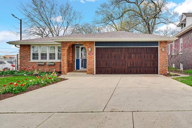 ranch-style house with an attached garage, driveway, brick siding, and roof with shingles