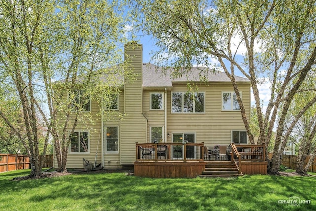 rear view of house featuring a deck and a chimney