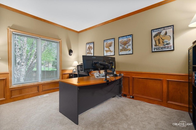 home office with a wainscoted wall, light carpet, crown molding, and a decorative wall