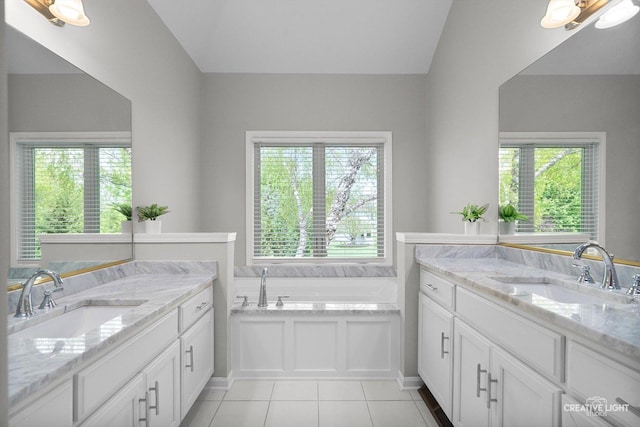 full bathroom with tile patterned floors, two vanities, and plenty of natural light