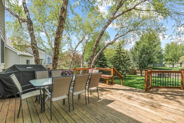 wooden terrace with outdoor dining area and area for grilling