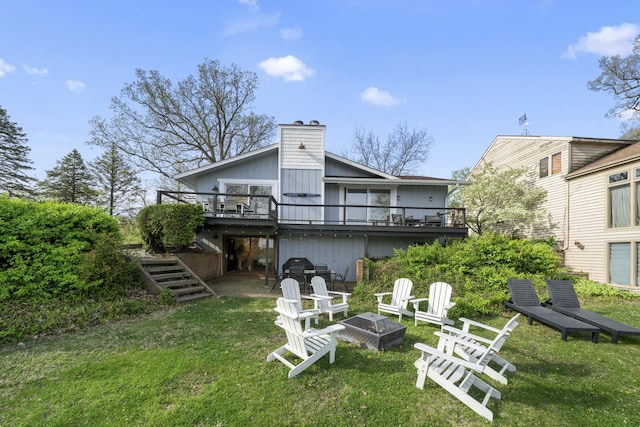 209 Oak Cv, Lake Holiday, IL 60552 - back of house featuring a deck, a chimney, stairs, a lawn, and an outdoor fire pit