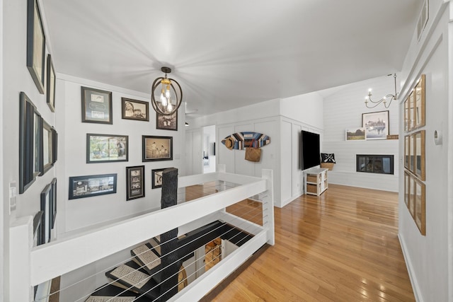 209 Oak Cv, Lake Holiday, IL 60552 - hall featuring an inviting chandelier, wood finished floors, and visible vents