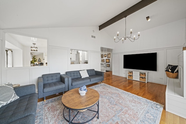 209 Oak Cv, Lake Holiday, IL 60552 - living area featuring high vaulted ceiling, beamed ceiling, wood finished floors, and a chandelier