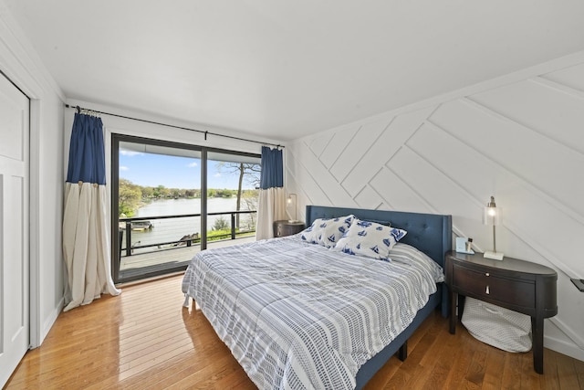 209 Oak Cv, Lake Holiday, IL 60552 - bedroom with a water view, access to outside, wood-type flooring, and lofted ceiling