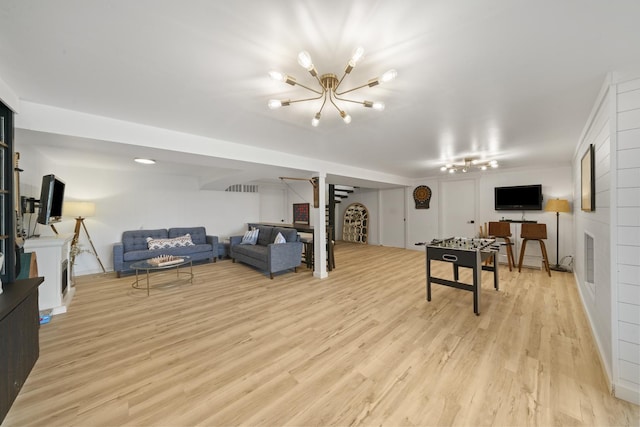 209 Oak Cv, Lake Holiday, IL 60552 - living area with an inviting chandelier and light wood-style flooring
