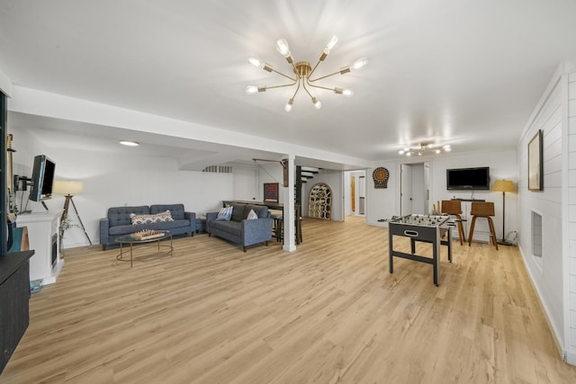 209 Oak Cv, Lake Holiday, IL 60552 - living room featuring a fireplace, light wood finished floors, and a notable chandelier