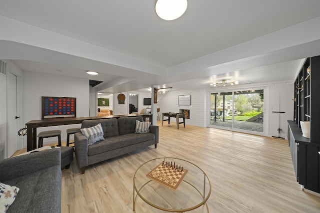 209 Oak Cv, Lake Holiday, IL 60552 - living room featuring a raised ceiling and light wood-style flooring