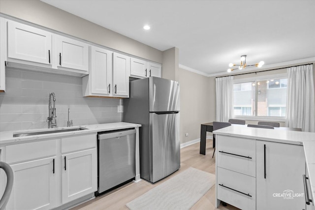 4425 Blackhawk Ln Unit 201, Lisle, IL 60532 - kitchen featuring stainless steel appliances, a chandelier, backsplash, white cabinetry, and light wood-style flooring