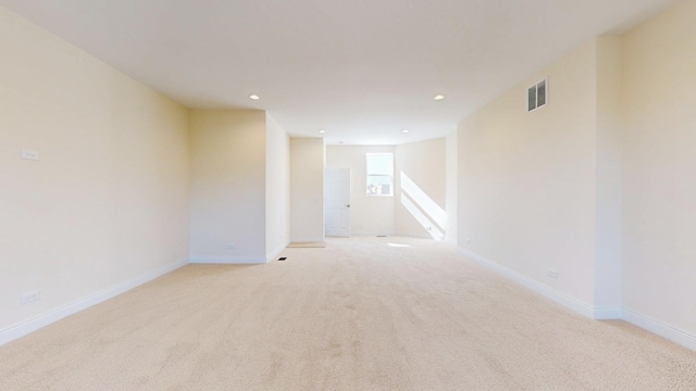 spare room with light carpet, baseboards, visible vents, and recessed lighting