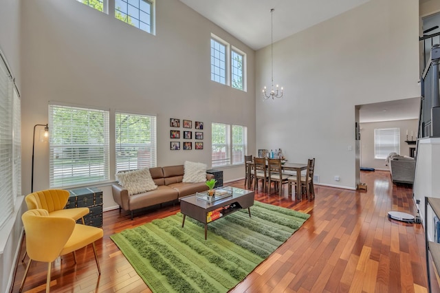2704 Flagstone Cir, Naperville, IL 60564 - living room with a chandelier, baseboards, a high ceiling, and hardwood / wood-style floors