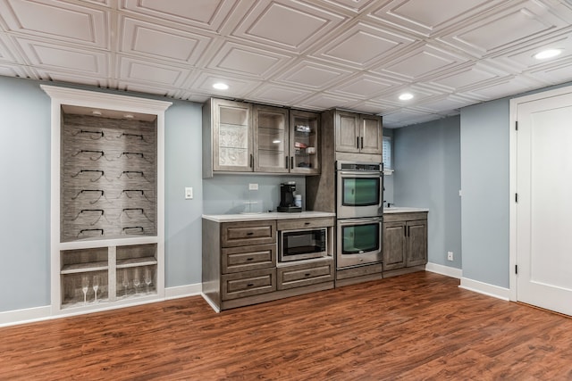 2704 Flagstone Cir, Naperville, IL 60564 - bar with dark wood-type flooring, baseboards, recessed lighting, and stainless steel appliances