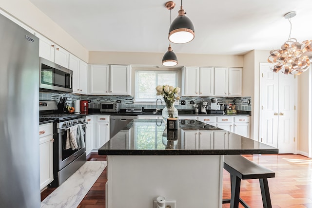 2704 Flagstone Cir, Naperville, IL 60564 - kitchen featuring tasteful backsplash, a kitchen breakfast bar, a chandelier, white cabinets, and stainless steel appliances