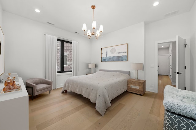 bedroom featuring recessed lighting, light wood-style flooring, visible vents, and an inviting chandelier