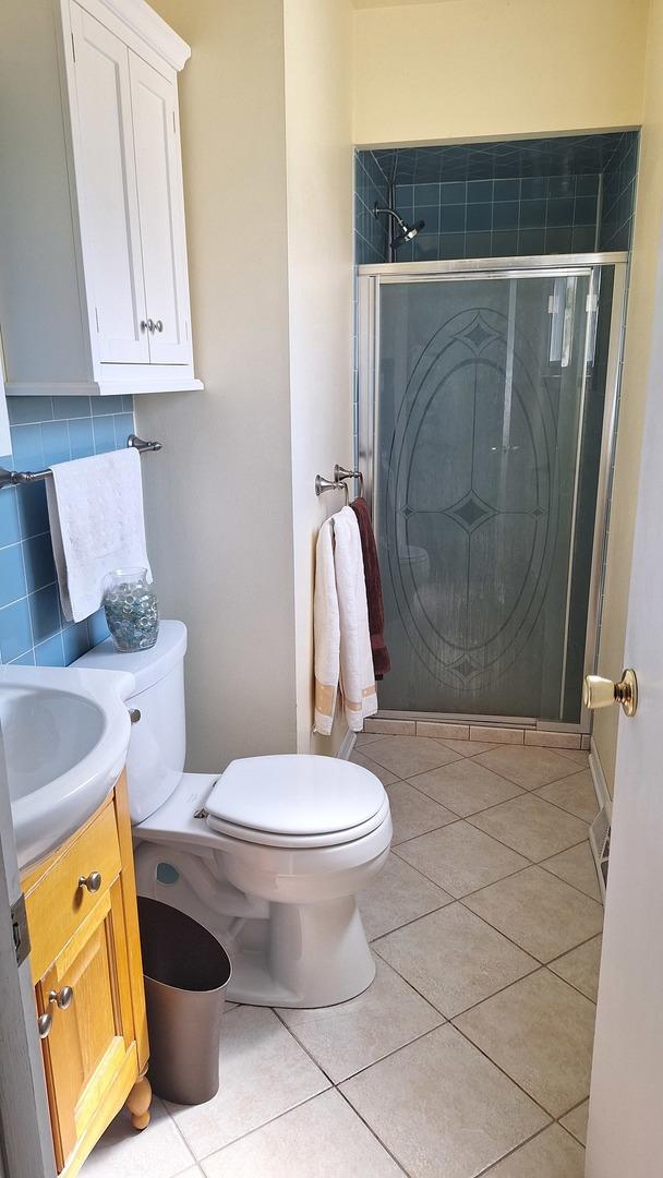 1344 Jeffery Dr, Homewood, IL 60430 - full bathroom with tile patterned flooring, toilet, a stall shower, and vanity