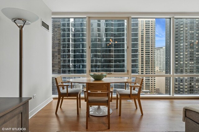 505 N Mcclurg Ct Unit 1801, Chicago, IL 60611 - dining area with wood finished floors, baseboards, and a city view