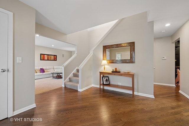 interior space with stairs, recessed lighting, baseboards, and wood finished floors