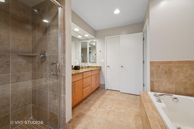 bathroom with a garden tub, recessed lighting, a stall shower, and vanity