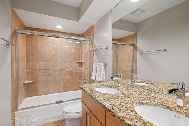 bathroom featuring a sink, toilet, and visible vents