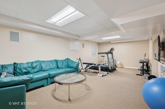 exercise room with carpet floors, baseboards, and a paneled ceiling
