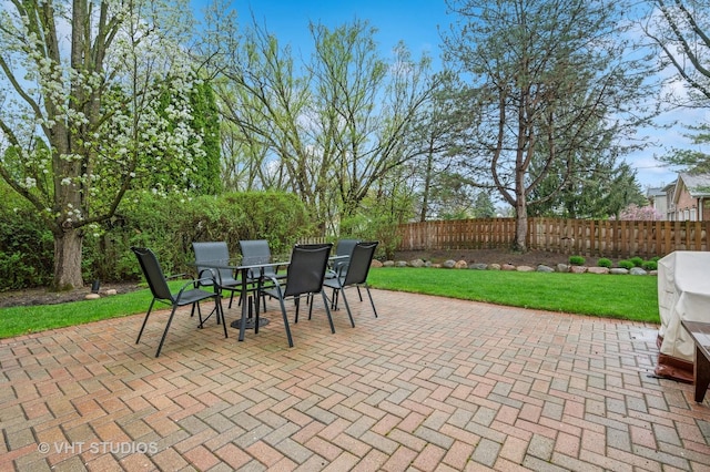 view of patio featuring outdoor dining area and fence