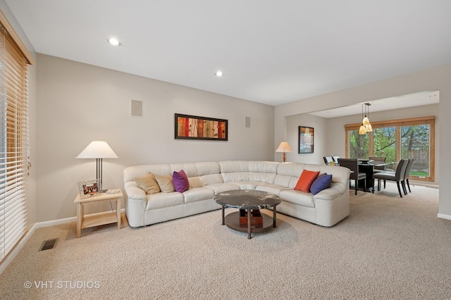 carpeted living room with recessed lighting, baseboards, and visible vents