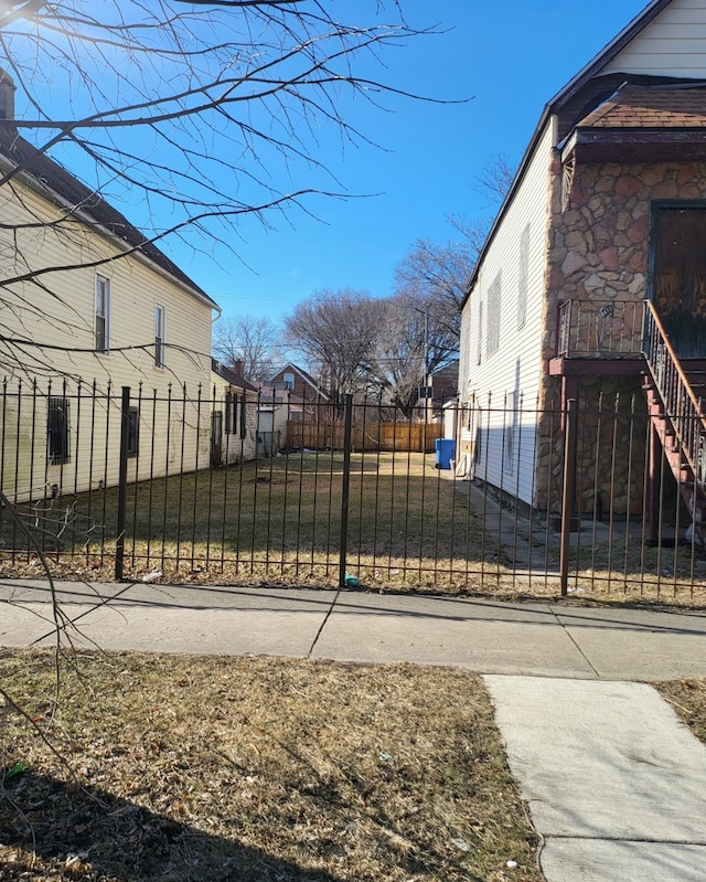 8418 S Colfax Ave, Chicago, IL 60617 - exterior space featuring a lawn, stairs, and a fenced front yard