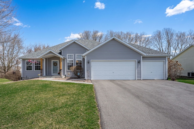 ranch-style house with central air condition unit, an attached garage, driveway, and a front lawn