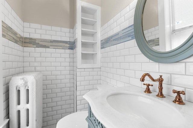 206 Franklin Pl, Rockford, IL 61103 - bathroom with tile walls, vanity, toilet, and radiator heating unit