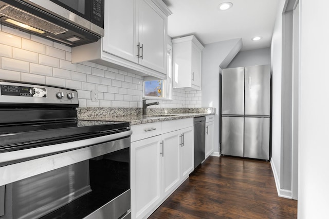206 Franklin Pl, Rockford, IL 61103 - kitchen featuring stainless steel appliances, a sink, light stone counters, decorative backsplash, and dark wood-style flooring