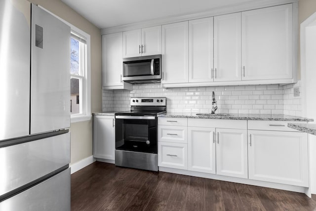 206 Franklin Pl, Rockford, IL 61103 - kitchen with stainless steel appliances, a sink, white cabinets, baseboards, and dark wood-style flooring