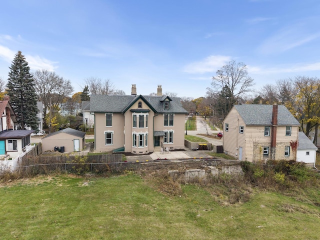 206 Franklin Pl, Rockford, IL 61103 - back of property featuring a chimney, a patio, and stucco siding