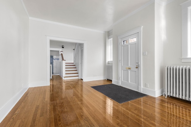 206 Franklin Pl, Rockford, IL 61103 - entryway with radiator heating unit, wood-type flooring, stairway, baseboards, and ornamental molding