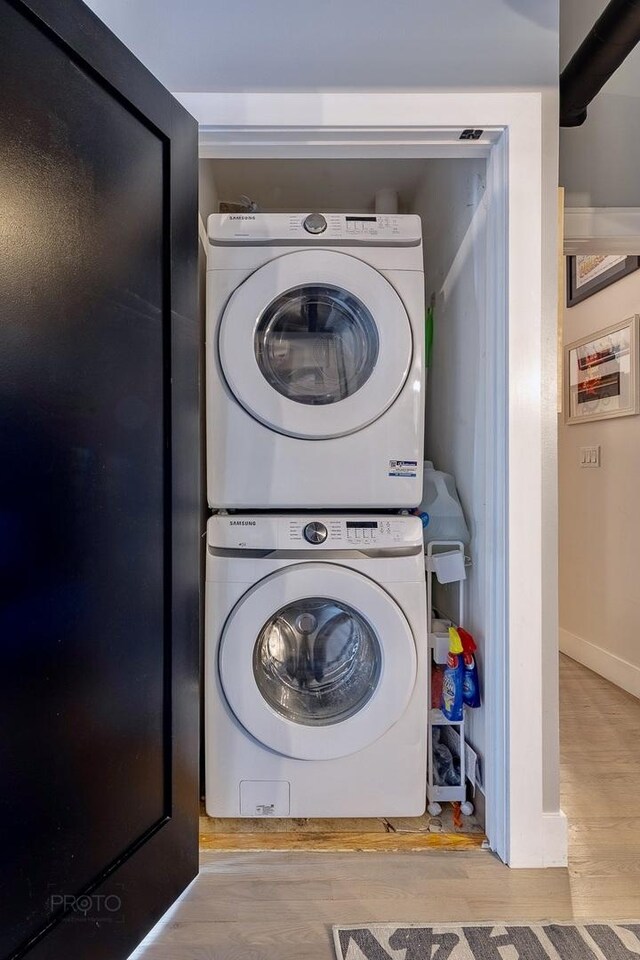 1070 W 15th St Unit 302, Chicago, IL 60608 - laundry area featuring estacked washer and dryer and wood finished floors