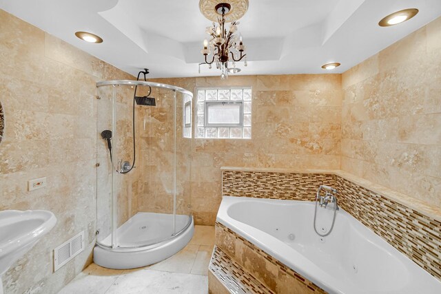 bathroom with tile walls, visible vents, a stall shower, and a jetted tub