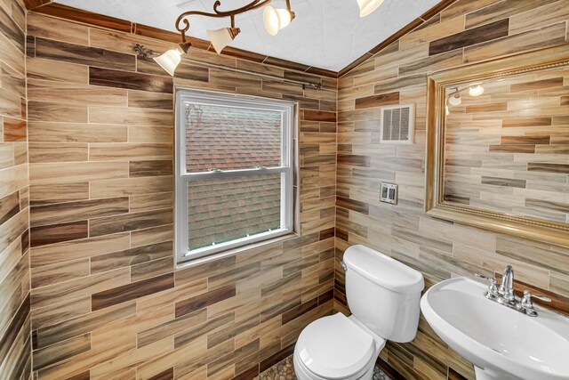 additional living space with lofted ceiling, wood finished floors, and baseboards