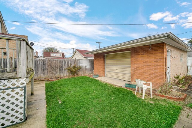 rear view of house featuring a fenced backyard, brick siding, and a patio