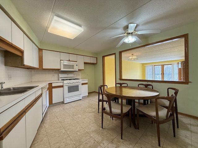 7120 N Milwaukee Ave Unit 305, Niles, IL 60714 - kitchen featuring white appliances, a textured ceiling, white cabinets, light countertops, and backsplash