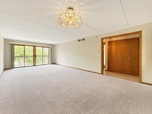 7120 N Milwaukee Ave Unit 305, Niles, IL 60714 - unfurnished room with a chandelier, carpet floors, and a textured ceiling