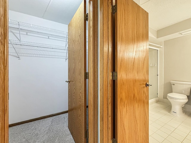 7120 N Milwaukee Ave Unit 305, Niles, IL 60714 - bathroom with a shower with door and tile patterned flooring