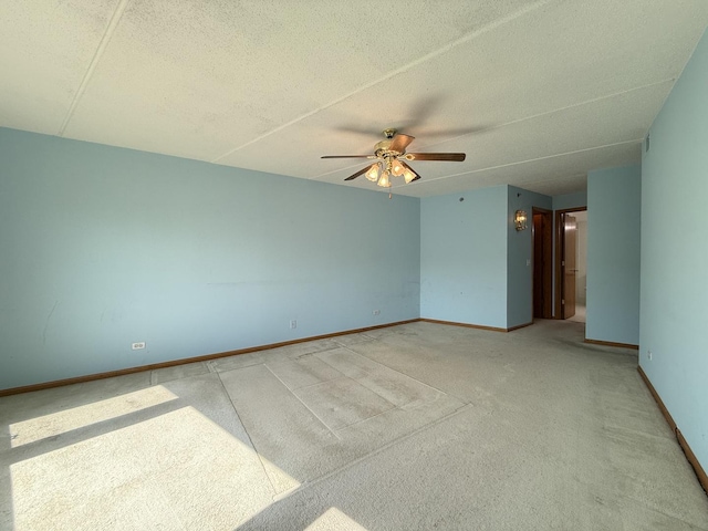 7120 N Milwaukee Ave Unit 305, Niles, IL 60714 - unfurnished room with baseboards, a ceiling fan, light colored carpet, and a textured ceiling